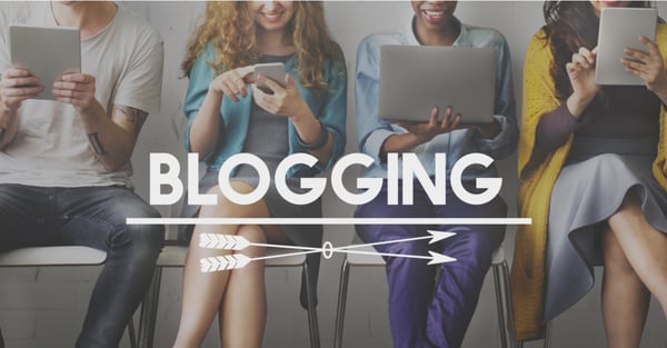 Blogging on the foreground of four people holding different mobile devices