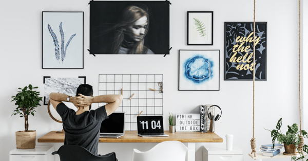 Man in a spacious, white office in modern, stylish home