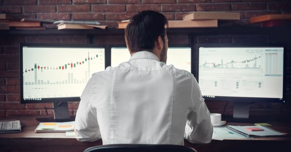 back view of a man monitoring Forex charts