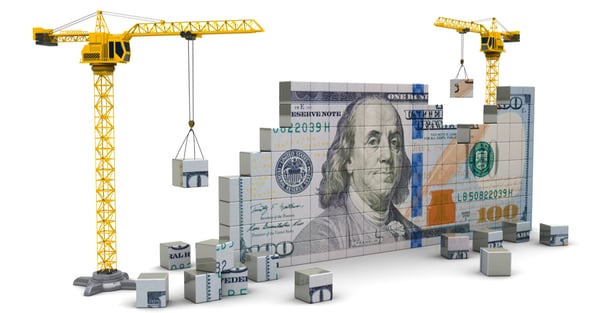 concept of building wealth represented by blocks that make up a dollar bill and cranes