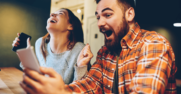 excited-male-and-female-rejoice-in-winning