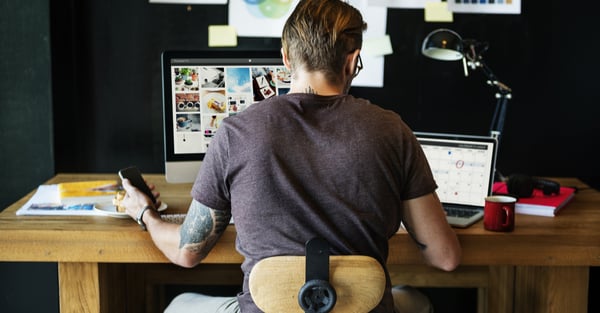 man_working_behind_his_desk_from_home
